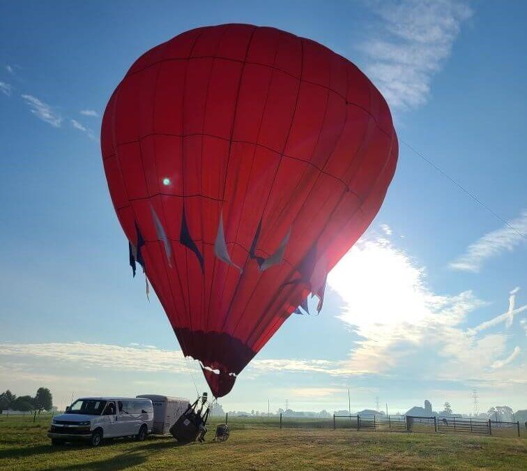 Red hot air balloon inflating.